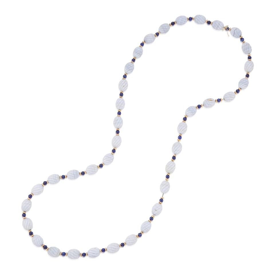 14K GOLD, CHALCEDONY, AND SODALITE NECKLACE: 14K GOLD, CHALCEDONY, AND SODALITE NECKLACE • 14K yellow gold • Numerous carved chalcedony beads measuring approximately 11.41mm in diameter • Numerous rounded sodalite beads
