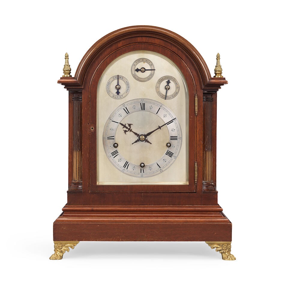 A good early 20th century mahogany cased three train, quarter chiming table clock Winterhalder a...: A good early 20th century mahogany cased three train, quarter chiming table clock Winterhalder and Hofmeier The arched case with moulded cornice flanked by twin finials over brass-inlaid fluted Doric 