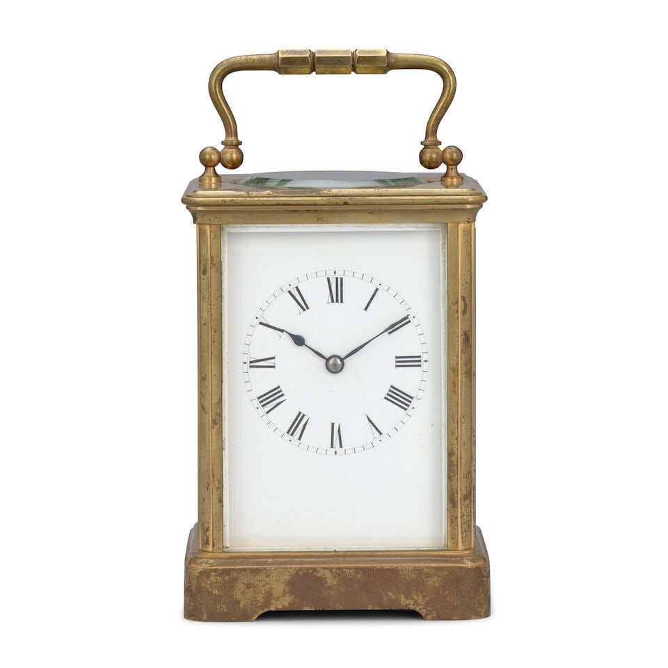 A late 19th century carriage clock timepiece RC, number 329: A late 19th century carriage clock timepiece RC, number 329 The case sumounted by a brass carrying handle over an oval observation window with simple sides and a moulded base, the 2.75 inch white