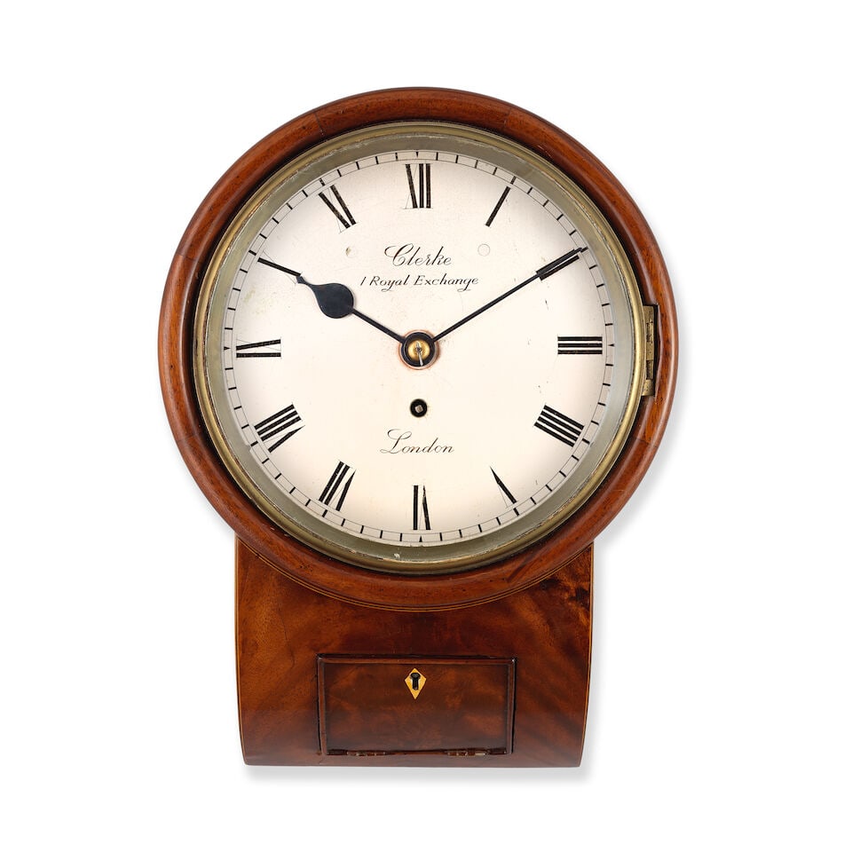 A late 19th century mahogany drop dial clock Clerke, 1 Royal Exchange: A late 19th century mahogany drop dial clock Clerke, 1 Royal Exchange The case with turned wood surround with sloped base with inset door with bone escutcheon and fine stringing with side door to the