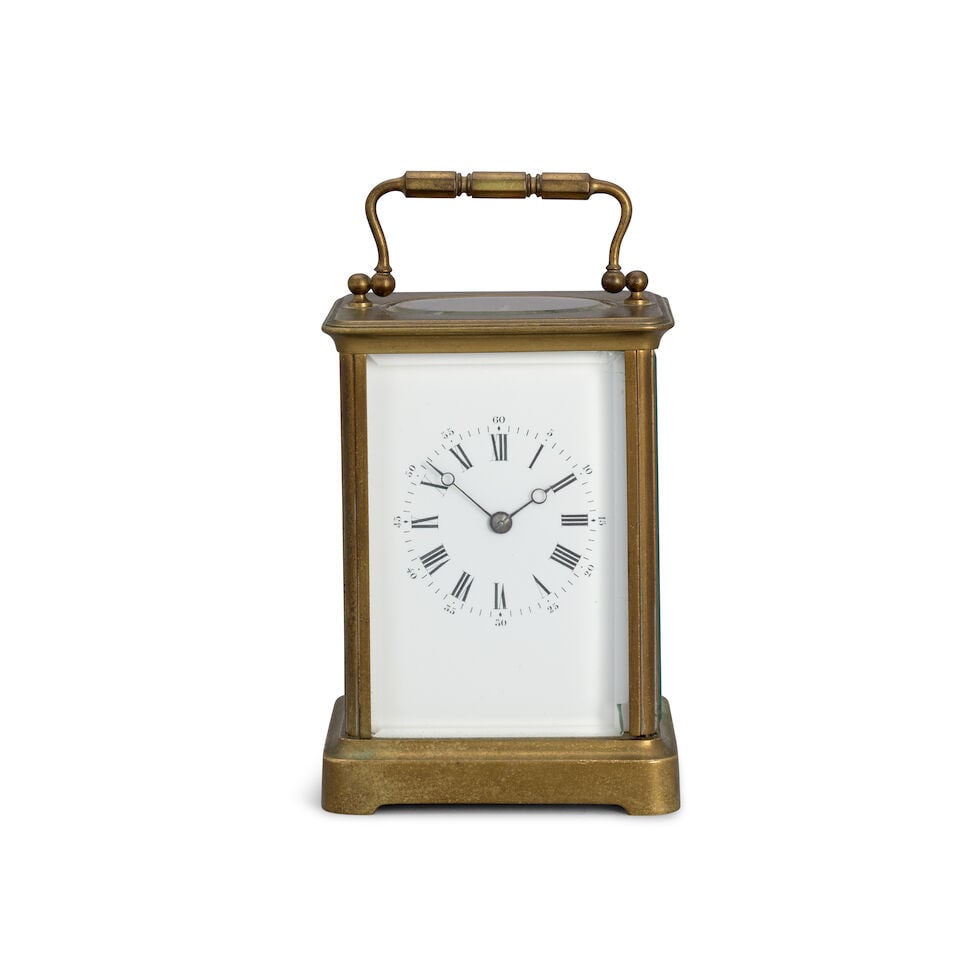 A late 19th century French striking carriage clock: A late 19th century French striking carriage clock The case surmounted by a simple brass carrying handle over an oval observation window, the moulded top supported by four simple uprights intercepted