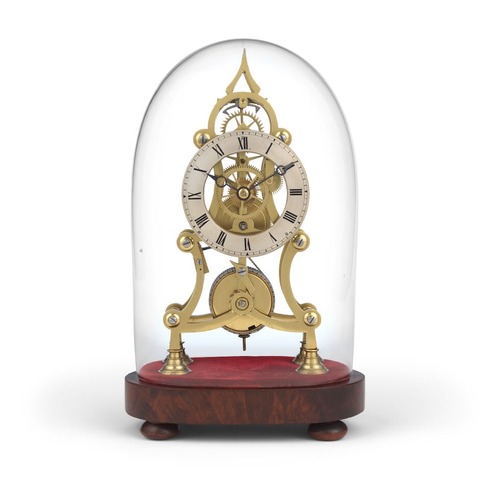 A late 19th century skeleton clock timepiece with dome: A late 19th century skeleton clock timepiece with dome The shaped frame sitting on four turned feet on a red velvet base with a mahogany veneered base further raised on four turned wooden feet. The