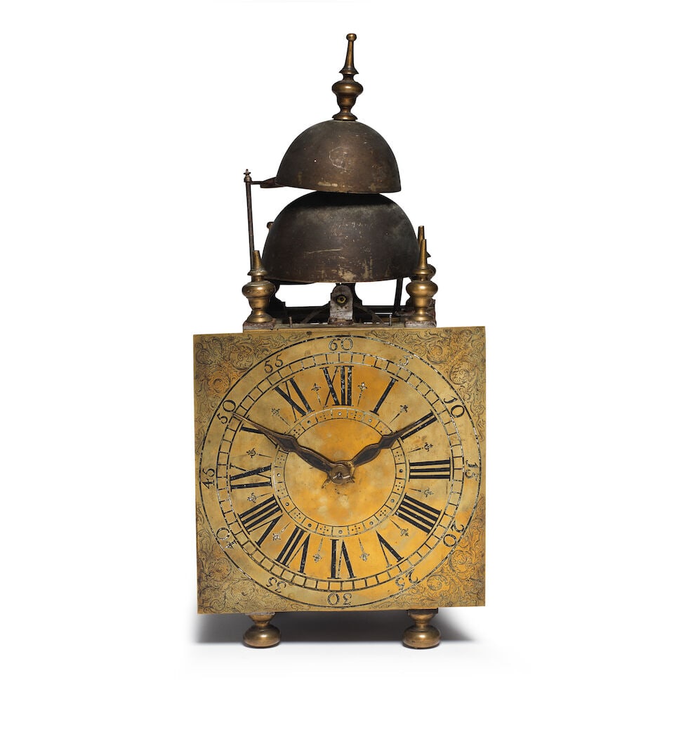 A mid 18th century North European quarter striking lantern clock: A mid 18th century North European quarter striking lantern clock The case surmounted by a turned finial over a pair of stacked bells, framed by four turned finials over square-section steel posts to e