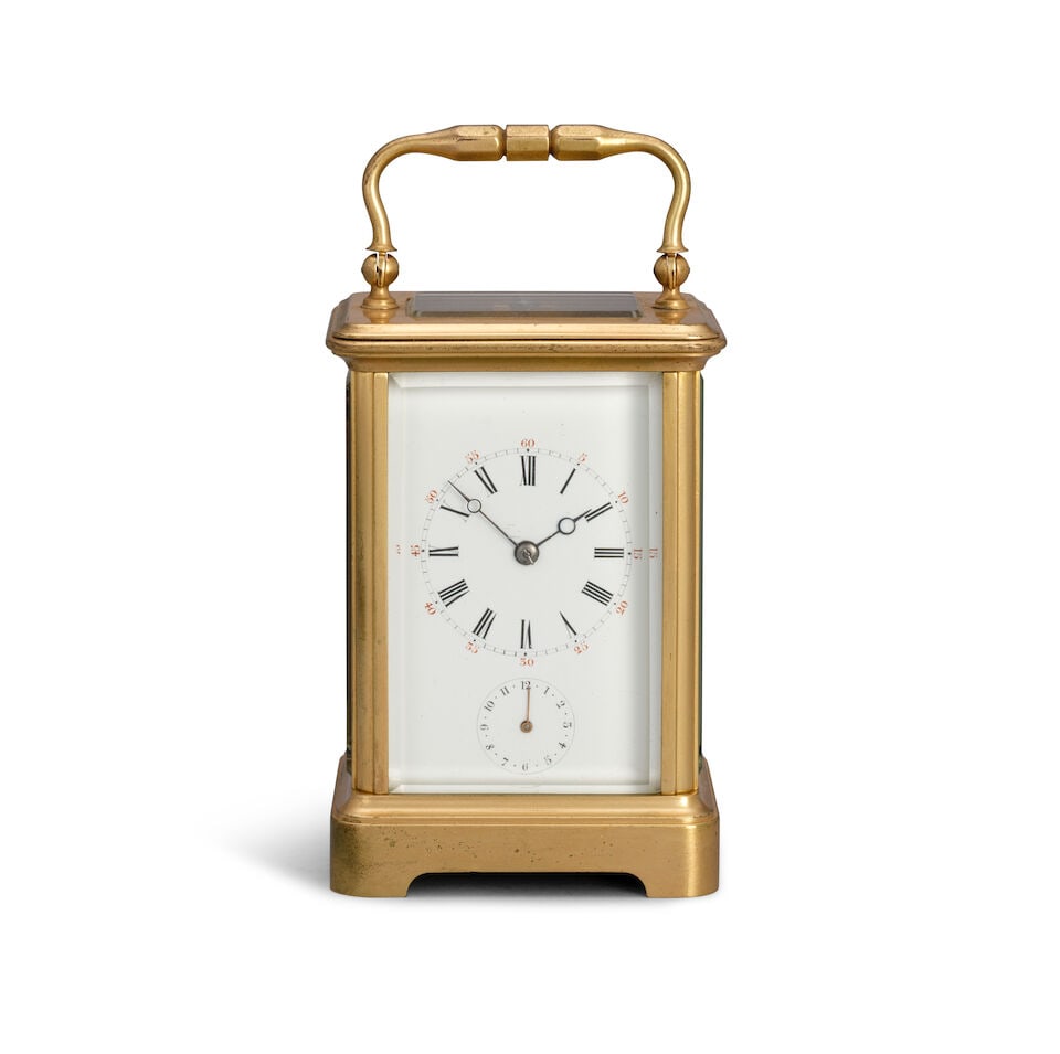 A late 19th century French Carriage clock with alarm: A late 19th century French Carriage clock with alarm The case surmounted by a simple carrying handle over a rectangular bevelled glass observation window and moulded top, supported by four plain uprig