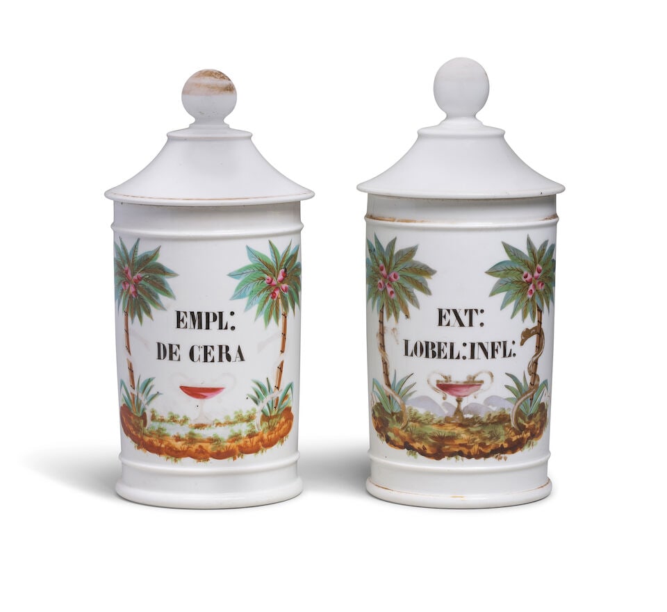 A pair of Paris porcelain apothecary jars and covers, second quarter 19th century: A pair of Paris porcelain apothecary jars and covers, second quarter 19th century Painted with the drug labels 'EMPL:/ DE CERA' and 'EXT:/ LOBEL:INFL:', respectively, flanked by snakes entwined