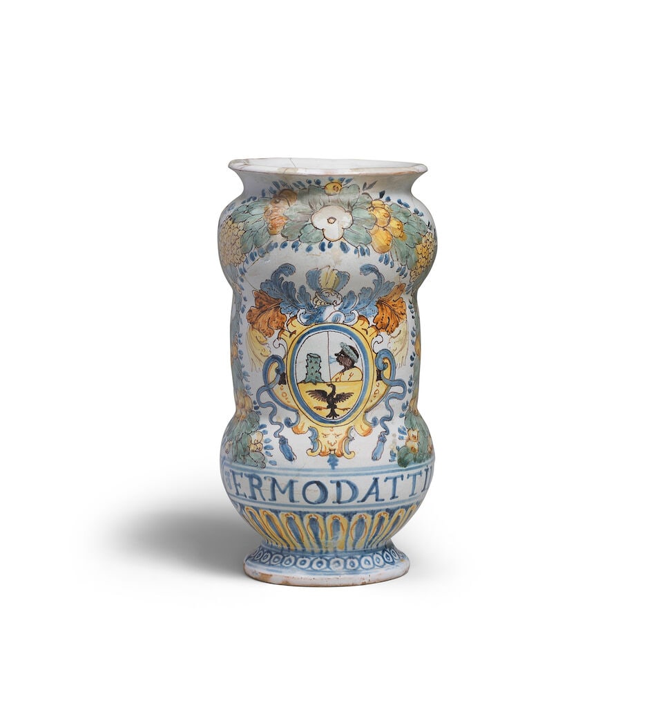A Castelli maiolica armorial albarello, second half 17th century: A Castelli maiolica armorial albarello, second half 17th century Painted in polychrome enamels with a coat of arms enclosed within a fruiting and floral wreath above a drug label inscribed in blue