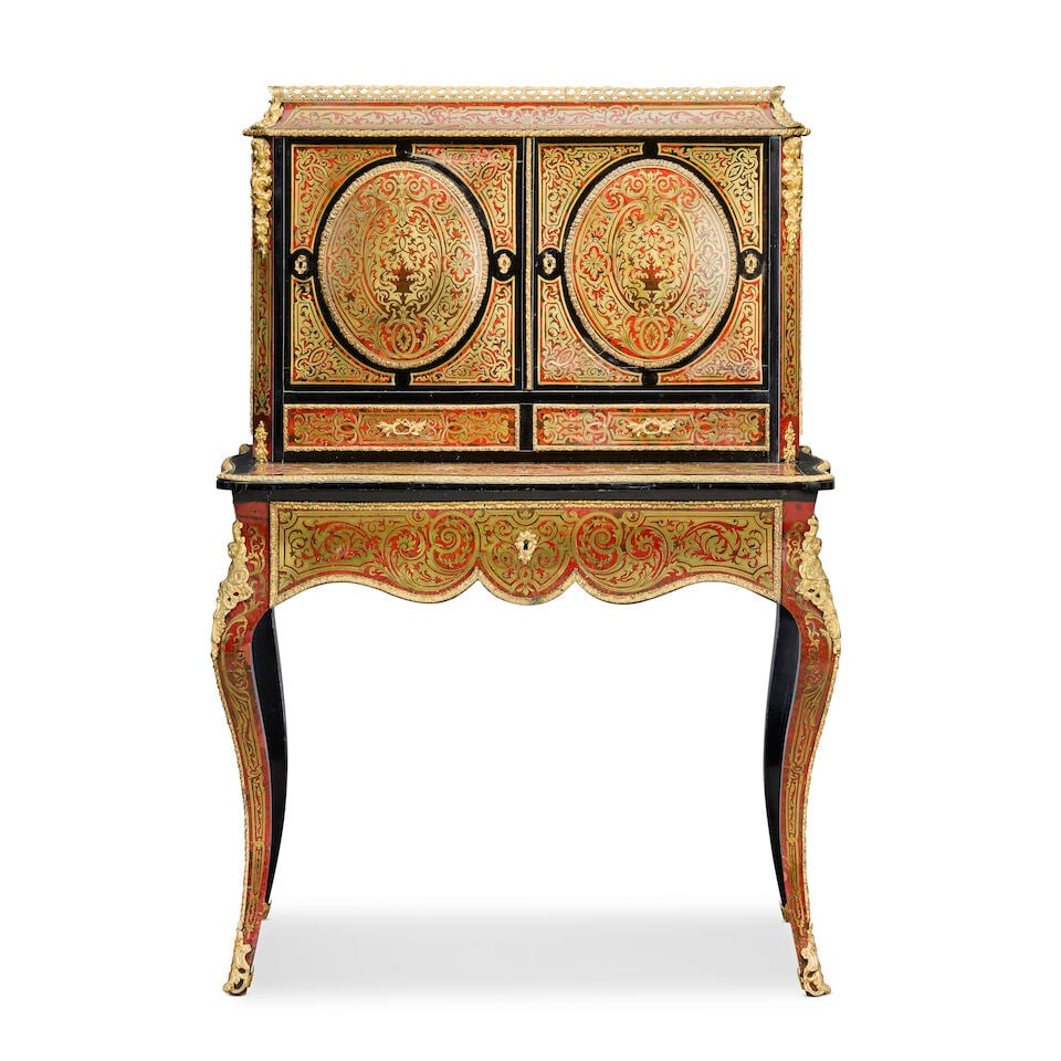 A French early 20th century ebonised, gilt metal mounted, red stained tortoiseshell and cut bras...: A French early 20th century ebonised, gilt metal mounted, red stained tortoiseshell and cut brass inlaid 'Boulle' bonheur du jour With a pair of panelled doors above two shorty drawers and a frieze dr