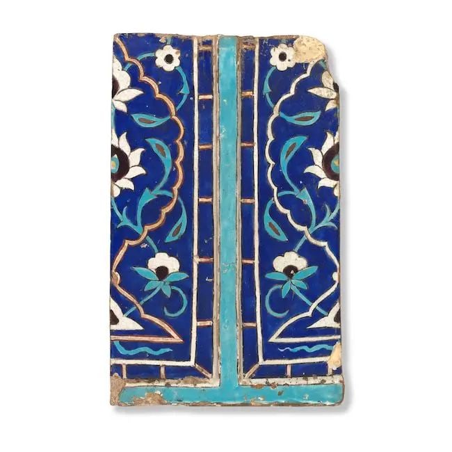A large Timurid moulded cuerda seca pottery tile Central Asia, probably Uzbekistan, early 15th C...: A large Timurid moulded cuerda seca pottery tile Central Asia, probably Uzbekistan, early 15th Century of rectangular form, decorated in cobalt-blue, turquoise, manganese and red on a cream ground wit