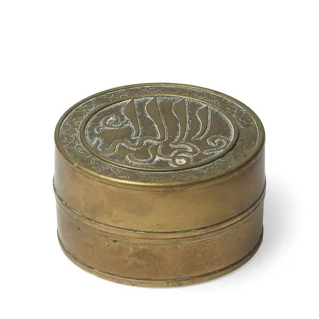 A brass box and cover for the Islamic market China, 16th/ 17th Century: A brass box and cover for the Islamic market China, 16th/ 17th Century of cylindrical form, the flat cover cast to the top with a roundel containing an inscription in Arabic, the roundel surrounded by