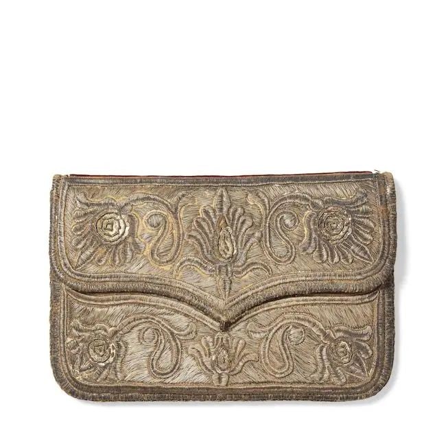 A metal-thread embroidered velvet-mounted leather wallet Ottoman Turkey or Caucasus, 17th Century: A metal-thread embroidered velvet-mounted leather wallet Ottoman Turkey or Caucasus, 17th Century of rectangular form with cusped flap, the red morocco profusely embroidered in gilt silver thread with