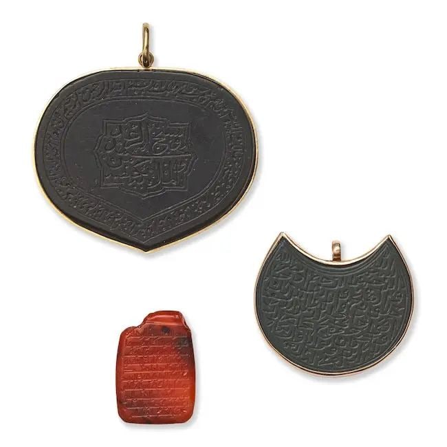 Two jade talismanic plaques Persia, 17th-19th Century (3): Two jade talismanic plaques Persia, 17th-19th Century of heart and crescent form, the first engraved with inscription-filled central cartouche and border in thuluth and nasta'liq script respectively, 