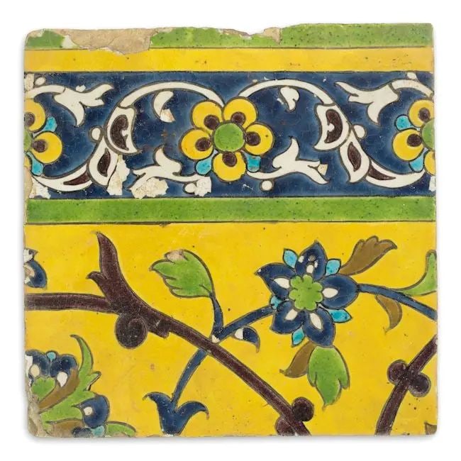 A Safavid cuerda seca pottery tile Persia, 17th Century: A Safavid cuerda seca pottery tile Persia, 17th Century of square form, decorated in yellow, cobalt-blue, turquoise, green, ochre and manganese on a white ground with floral and foliate interlace to c
