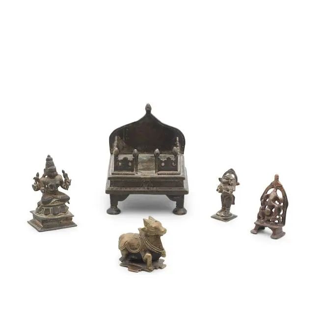 A group of five bronzes India, 16th-18th Century(5): A group of five bronzes India, 16th-18th Century comprising a figure of Nandi, recumbent, adorned with jewellery, on a cruciform base; a figure of Ganesh seated on a throne with arched back; a figure 