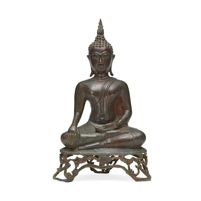 A bronze figure of seated Buddha as Maravijaya Ayutthaya, Thailand, 16th/ 17th Century: A bronze figure of seated Buddha as Maravijaya Ayutthaya, Thailand, 16th/ 17th Century seated cross-legged on an openwork scrolling lotus pedestal, touching the earth with his right hand to bear witne