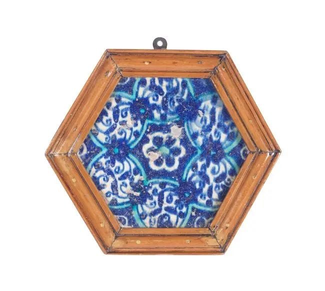 A Mughal underglaze-painted pottery tile Sindh, 16th Century: A Mughal underglaze-painted pottery tile Sindh, 16th Century of hexagonal form, decorated in cobalt blue and turquoise on a white ground with a central rosette surrounded by interconnected circular mo