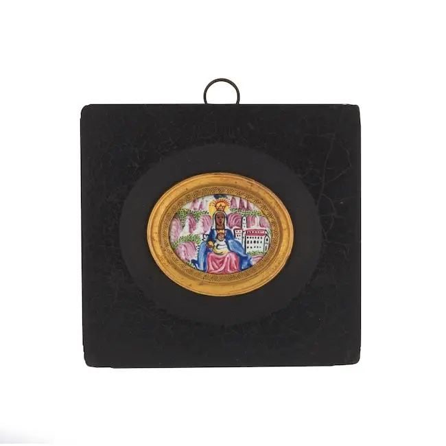 A Qajar enamel plaque depicting the Virgin of Montserrat Persia, 18th/ 19th Century: A Qajar enamel plaque depicting the Virgin of Montserrat Persia, 18th/ 19th Century of oval form, painted with the seated Virgin holding Jesus in her lap, the mountains of Montserrat and monastery of 
