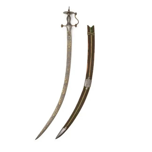 A rare gold-koftgari steel sword (tulwar) depicting Guru Nanak and Hindu deities North India, se... (1 of 1)