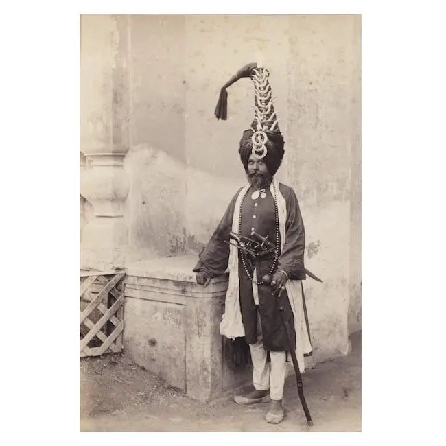 A rare photograph of the famous Akali Nihang, Hira Singh India, circa 1880(2): A rare photograph of the famous Akali Nihang, Hira Singh India, circa 1880 albumen print, laid down on card, contemporary English inscription Chalkar; verso a group photograph of a British family, the