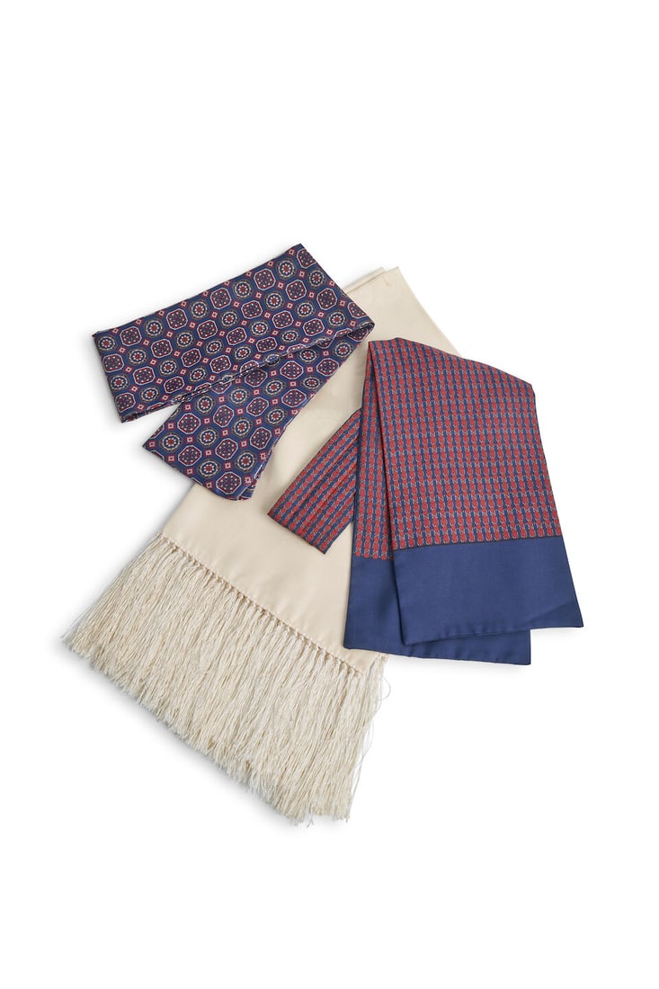 Yves Saint Laurent and Hermès | A silk evening scarf, a patterned cravat and a neck-tie: Yves Saint Laurent and Hermès | A silk evening scarf, a patterned cravat and a neck-tie Yves Saint Laurent pure silk evening scarf in cream with jacquard paisley pattern, together with a navy and