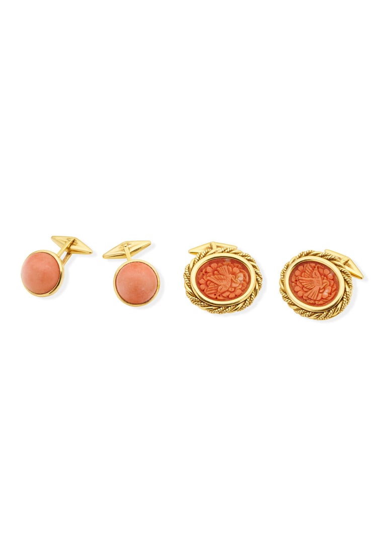 Two pairs of coral cufflinks: Two pairs of coral cufflinks one pair carved with bird and flower motif, framed in yellow gold, stamped 750, gross weight 24.2gm, plaque measuring 2.6 2.3cm, the second also framed in yellow gold, sta