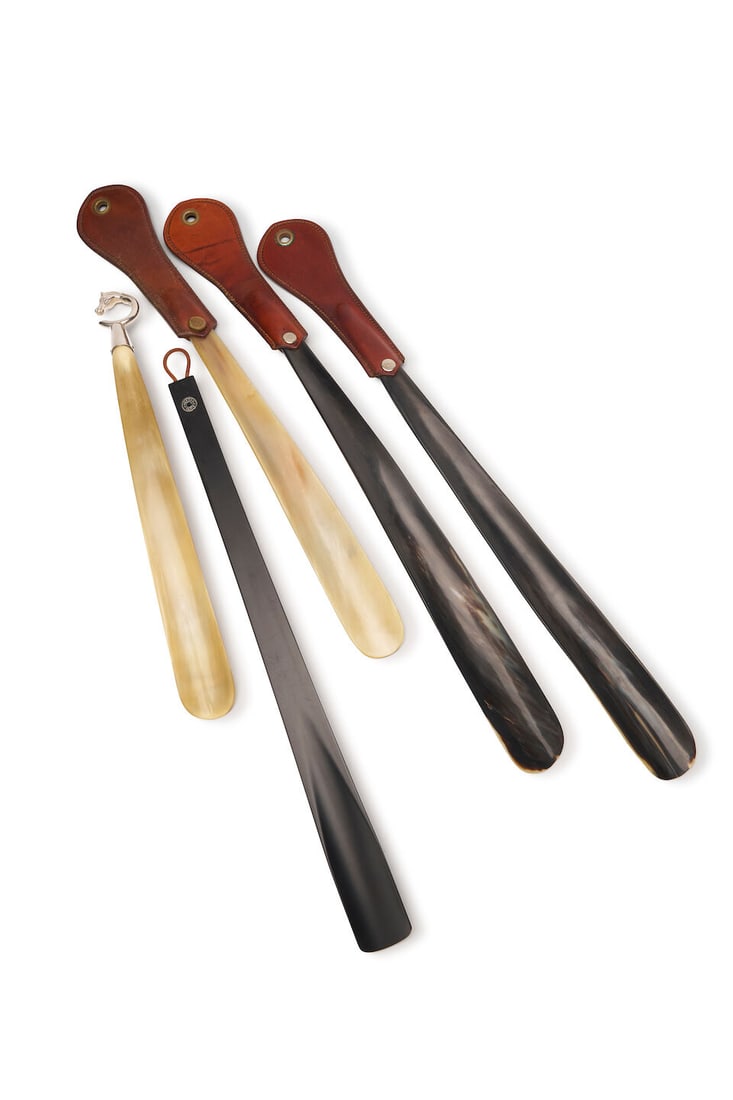 Hermès | sterling silver and horn shoehorn: Hermès | sterling silver and horn shoehorn With stylised horsehead handle and horn shoehorn, signed Hermes made in France, length 41.5cm. For further information on this lot please visit