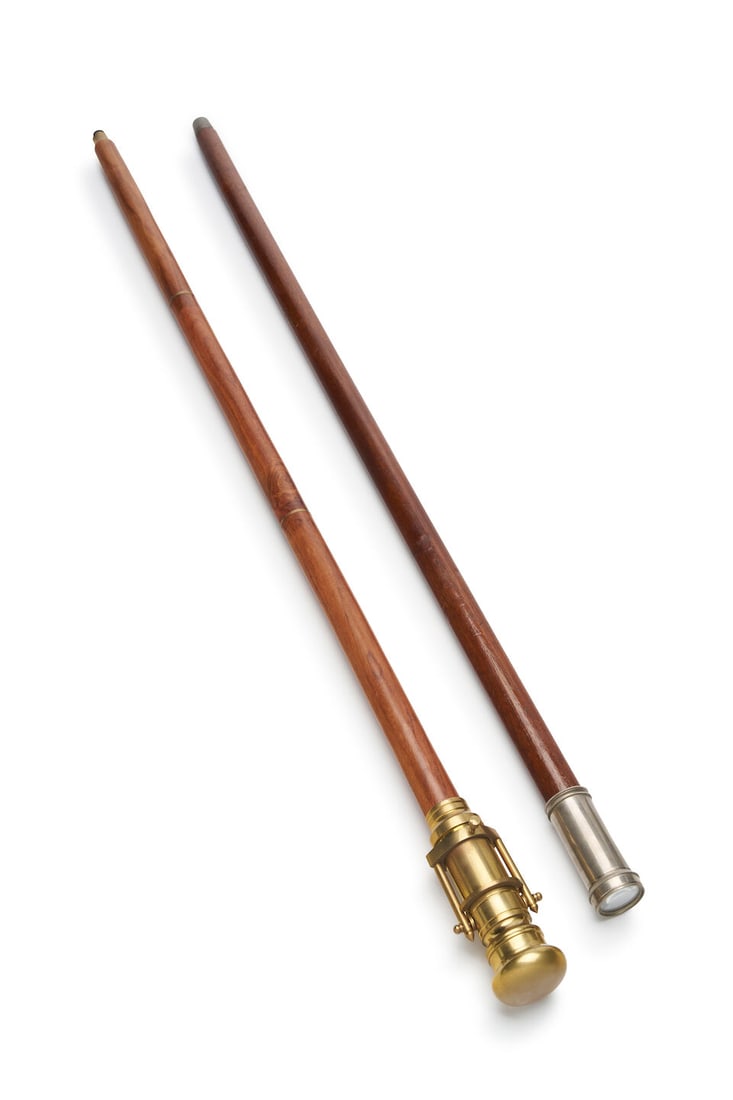 Two telescopic walking sticks English, 20th century (2): Two telescopic walking sticks English, 20th century The nautical-theme walking stick with articulated brass handle unscrewing to reveal an inner compartment housing a refracting telescope on hinged mo