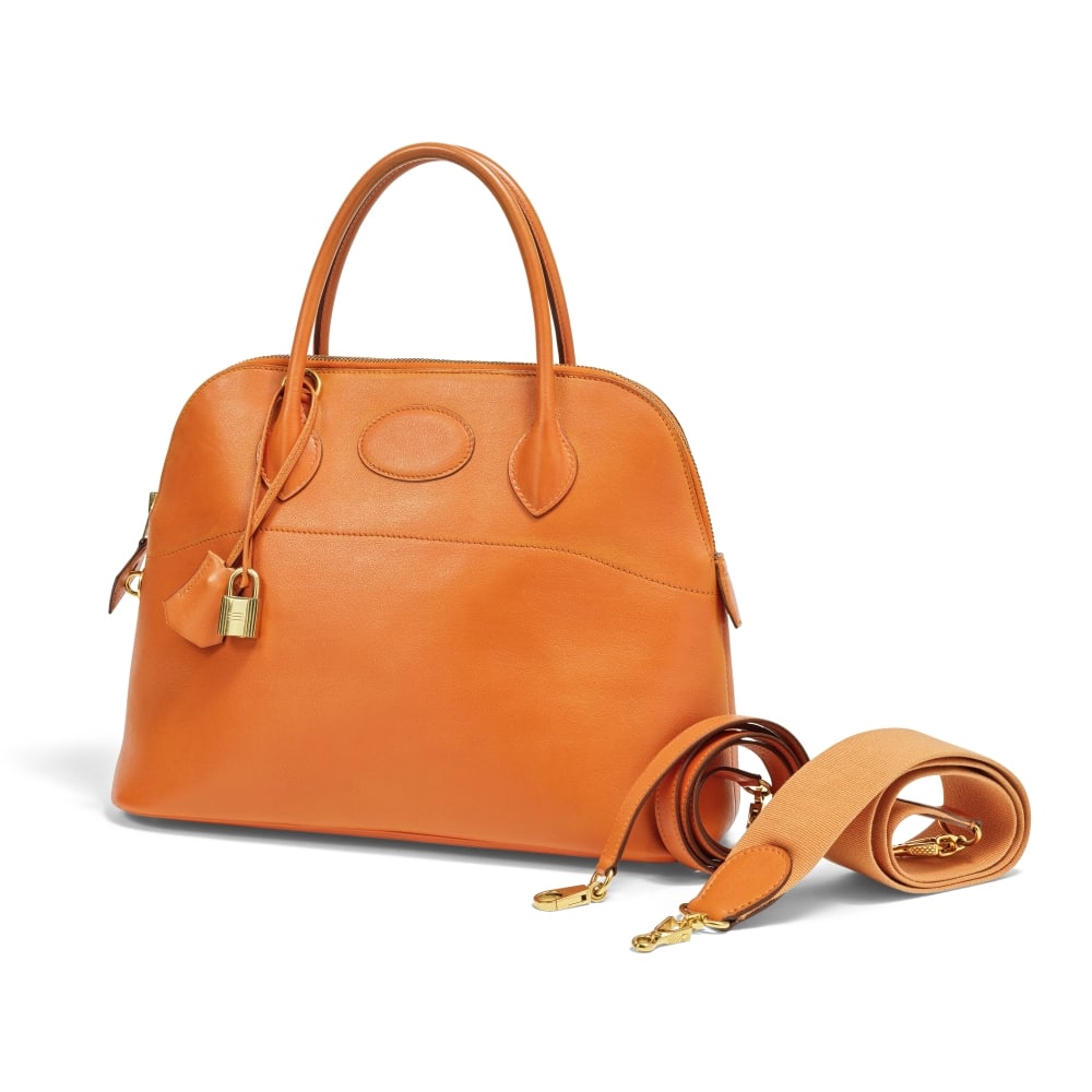 Hermès Paris, année 1994. Sac Bolide 32 en veau Gulliver orange. Hermès Paris, ye...: Hermès Paris, année 1994. Sac Bolide 32 en veau Gulliver orange. Hermès Paris, year 1994. Bolide 32 bag in orange Gulliver calfskin. Nous y joignons deux bandoulières une en cuir, 