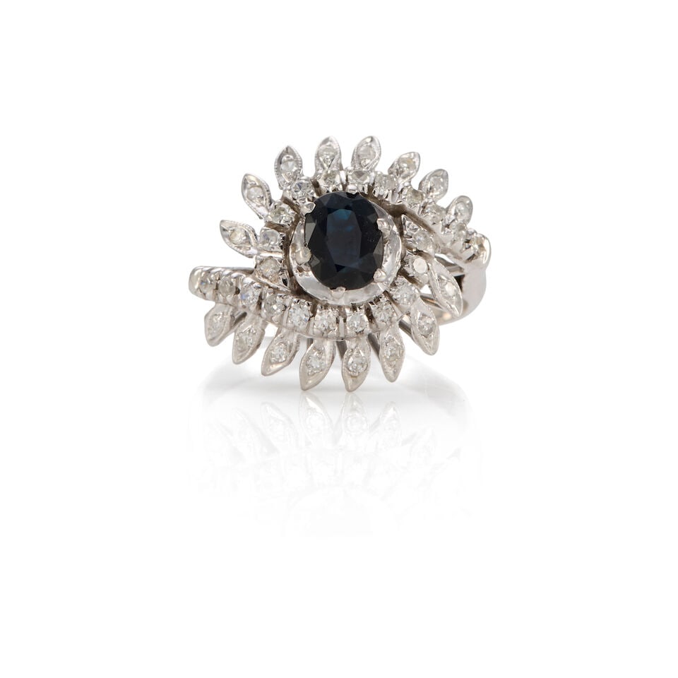 18K GOLD, SAPPHIRE AND DIAMOND RING: 18K GOLD, SAPPHIRE AND DIAMOND RING • 18k white gold • Numerous round diamonds weighing approximately 0.30 - 0.40 carat total • 1 oval sapphire weighing approximately 0.70 - 0.80