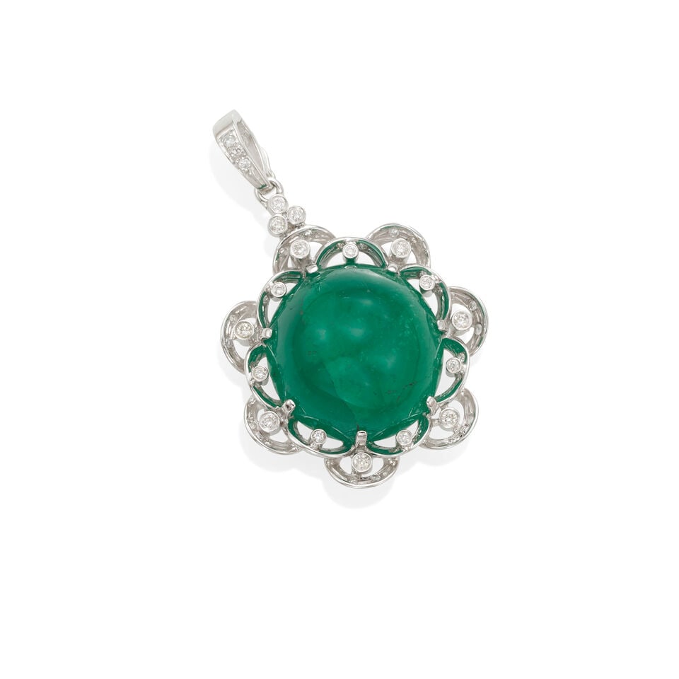 AN 18K GOLD, EMERALD AND DIAMOND ENHANCER: AN 18K GOLD, EMERALD AND DIAMOND ENHANCER • 18K white gold • One emerald cabochon weighing approximately 22.0 -24.0 carats • Numerous round shaped diamonds • Measures 1 1/2