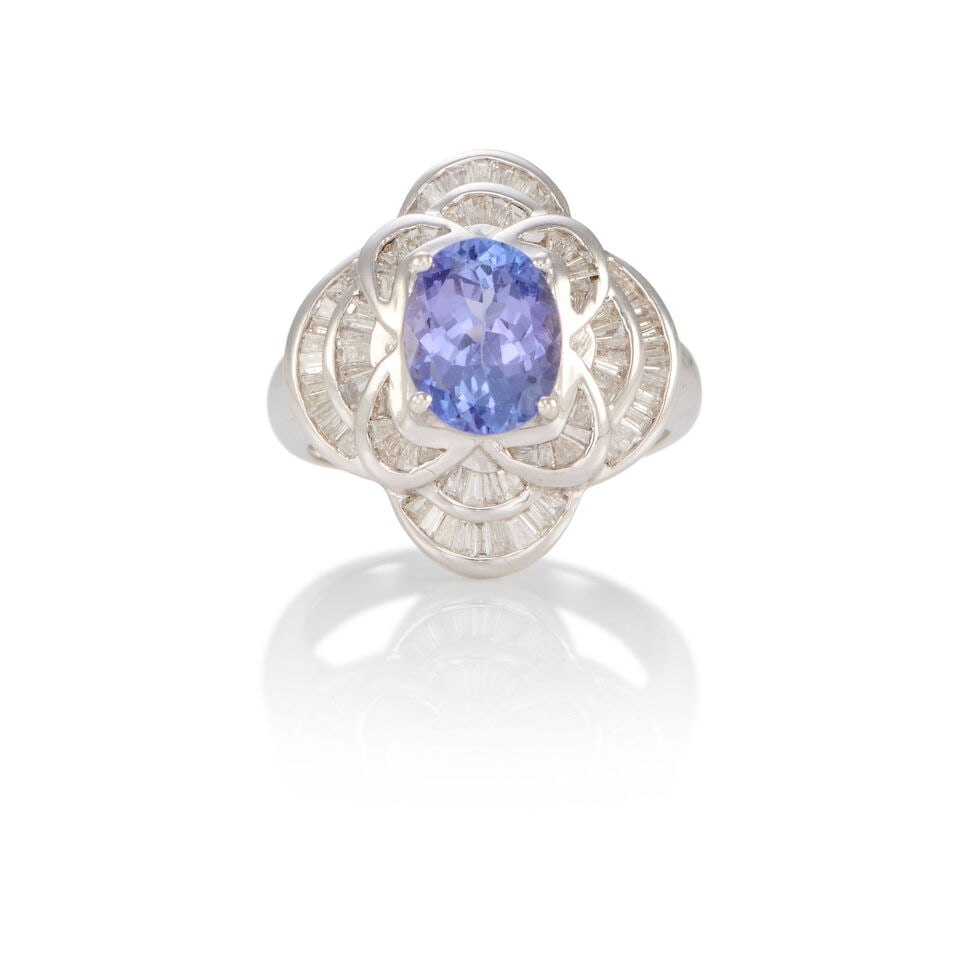 14K GOLD, TANZANITE AND DIAMOND RING: 14K GOLD, TANZANITE AND DIAMOND RING • 14k white gold • Numerous rectangular diamonds weighing approximately 0.70 - 0.80 carat total • 1 oval tanzanite weighing approximately 1.90 -