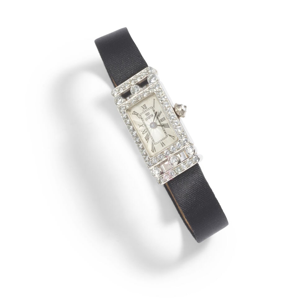 FRED LEIGHTON: AN 18K GOLD AND DIAMOND WRISTWATCH: FRED LEIGHTON: AN 18K GOLD AND DIAMOND WRISTWATCH • 18K white gold • Numerous round shaped diamonds weighing approximately 1.20 carats total • Signed FRED LEIGHTON on the dial •