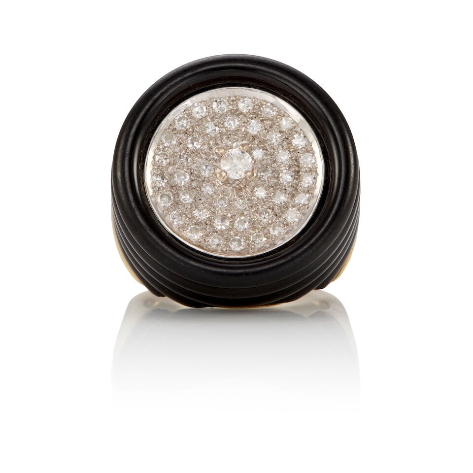 14K BICOLOR GOLD, DIAMOND AND ONYX RING: 14K BICOLOR GOLD, DIAMOND AND ONYX RING • 14k white and yellow gold • Numerous round diamonds weighing approximately 0.50 - 0.60 carat total • 1 carved onyx element • Size 6