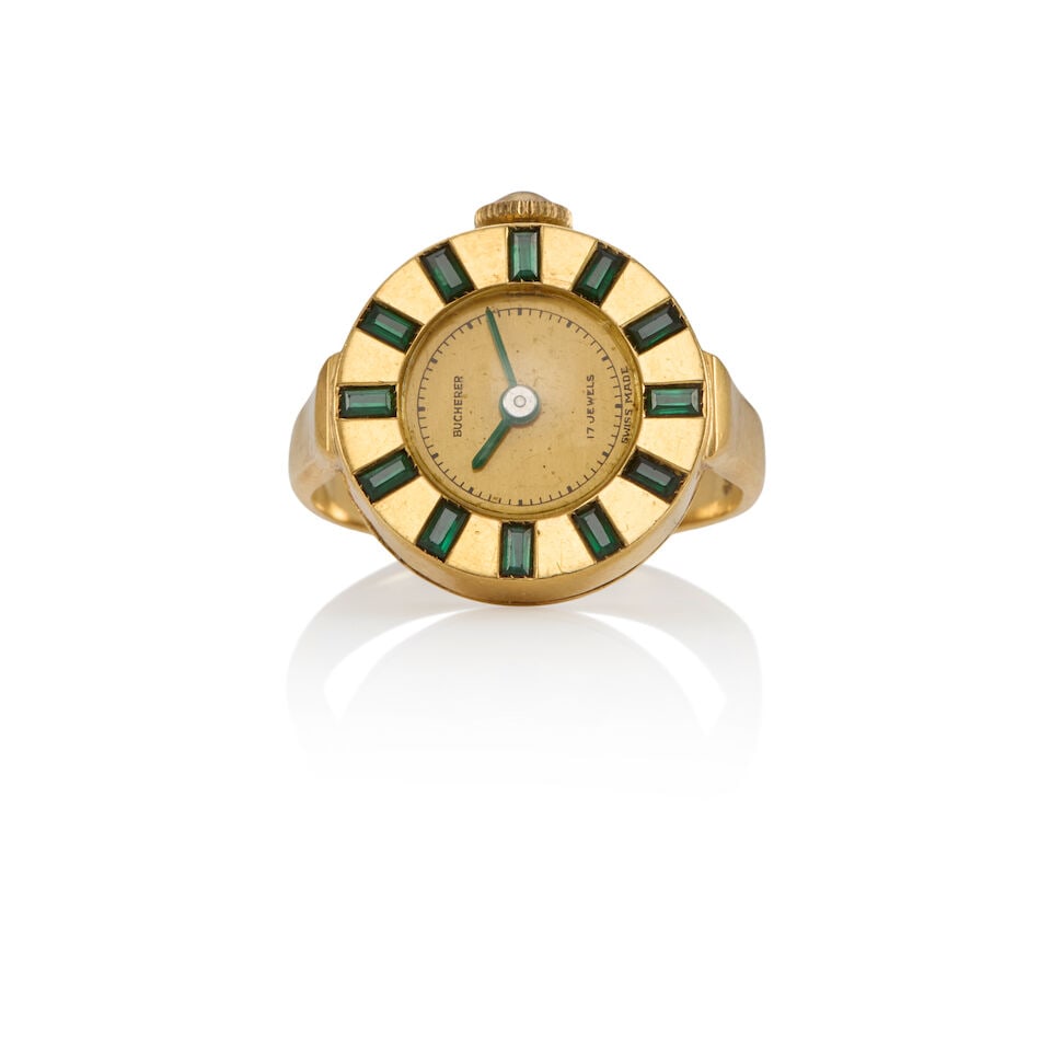 BUCHERER: VINTAGE 18K GOLD AND SYNTHETIC EMERALD WATCH RING: BUCHERER: VINTAGE 18K GOLD AND SYNTHETIC EMERALD WATCH RING • 18k yellow gold • 12 rectangular synthetic emeralds measuring approximately 1.55 - 2.55mm • Signed BUCHERER •
