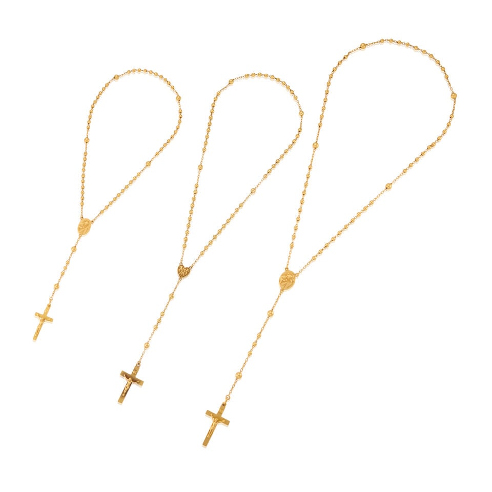 THREE GOLD ROSARY NECKLACES: THREE GOLD ROSARY NECKLACES • One rosary of 19k yellow gold with personal inscription on back of cross, length 18 in., length of central drop 5 1/4 in. • One rosary of 21k yellow gold
