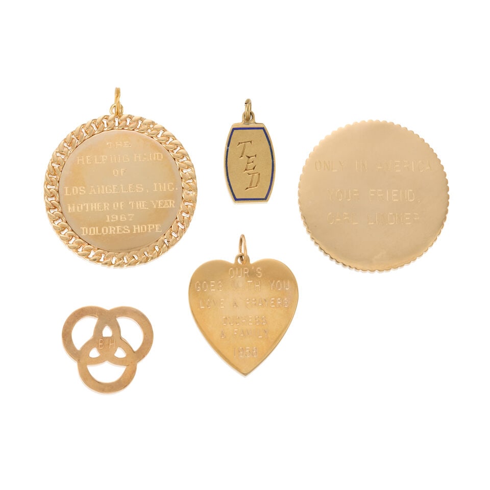 GROUP OF GOLD ITEMS: GROUP OF GOLD ITEMS • One heart charm of 13k yellow gold with personal inscription, measures 1 1/8 x 1 in. • One plaque of 14k yellow gold with personal inscription on both side, measures