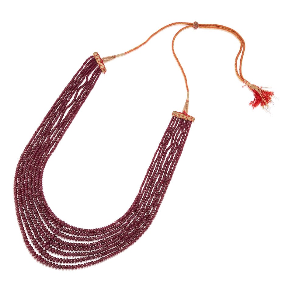 MULTISTRAND RUBY AND THREAD NECKLACE: MULTISTRAND RUBY AND THREAD NECKLACE • Woven colorful thread and string • Numerous graduated faceted emerald beads measuring approximately 2.71mm - 7.40mm in diameter • Length is adj