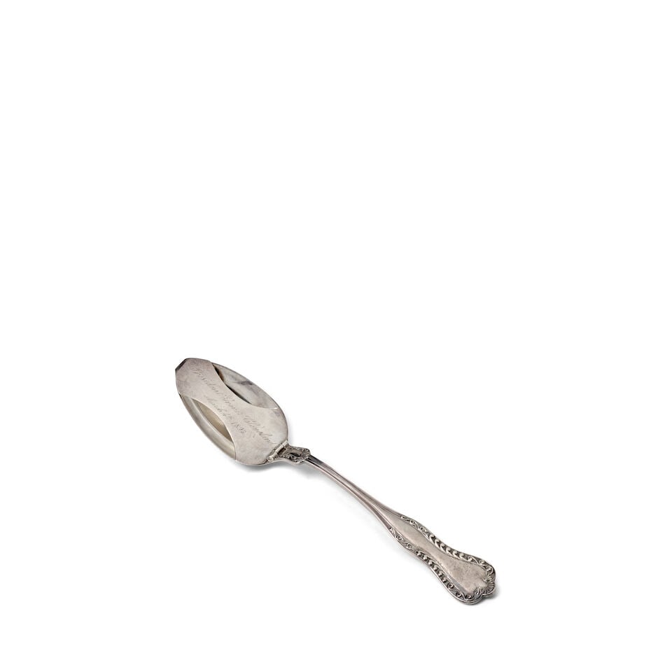 A Grover Cleveland Presentation Mustache Spoon.: A Grover Cleveland Presentation Mustache Spoon. A sterling silver oval soup spoon by Durgin, retailed by Shreve Crump and Low Co., with silver plated hinged mustache guard engraved 'President Grover