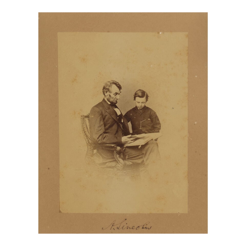 Signed Photograph of Lincoln with His Son Tad. LINCOLN, ABRAHAM. 1809-1865. BRADY, MATTHEW, pho...: Signed Photograph of Lincoln with His Son Tad. LINCOLN, ABRAHAM. 1809-1865. BRADY, MATTHEW, photographer. Original portrait photograph of Lincoln seated with a book and his son Tad, taken February 9,