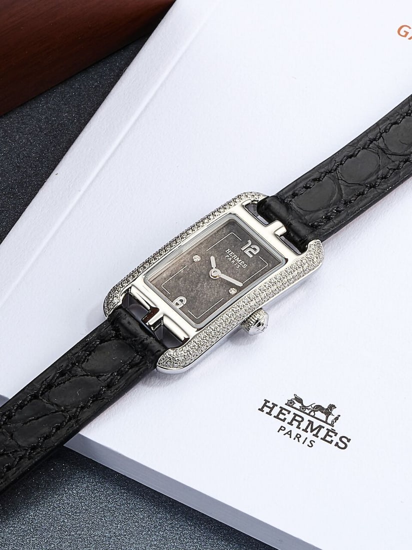 [NO RESERVE] HERMÈS | NANTUCKET, REF.NA2.130C, A STAINLESS STEEL AND DIAMOND-SET WRISTWATCH...: [NO RESERVE] HERMÈS | NANTUCKET, REF.NA2.130C, A STAINLESS STEEL AND DIAMOND-SET WRISTWATCH, CIRCA 2025 Case No: 3819957 Calibre: Quartz, signed Dial: Grey and diamond-set, signed Case: 17 x 32mm