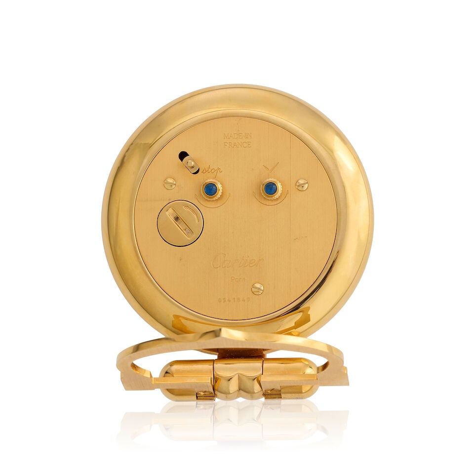 Cartier. A gilt brass quartz clock with alarm Colisée, Circa 1990 - 2