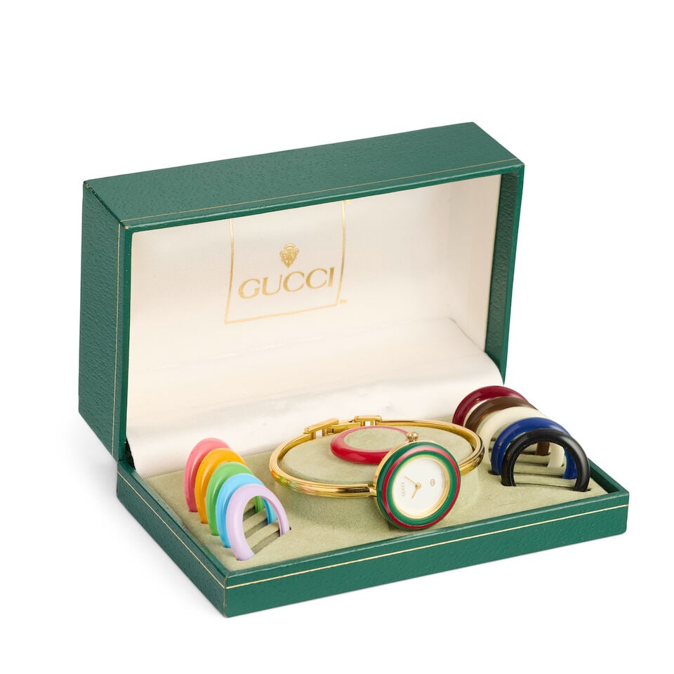 Gucci. A lady's gold tone quartz bracelet watch with interchangeable bezels Ref: 11/12, Purchase... - 2