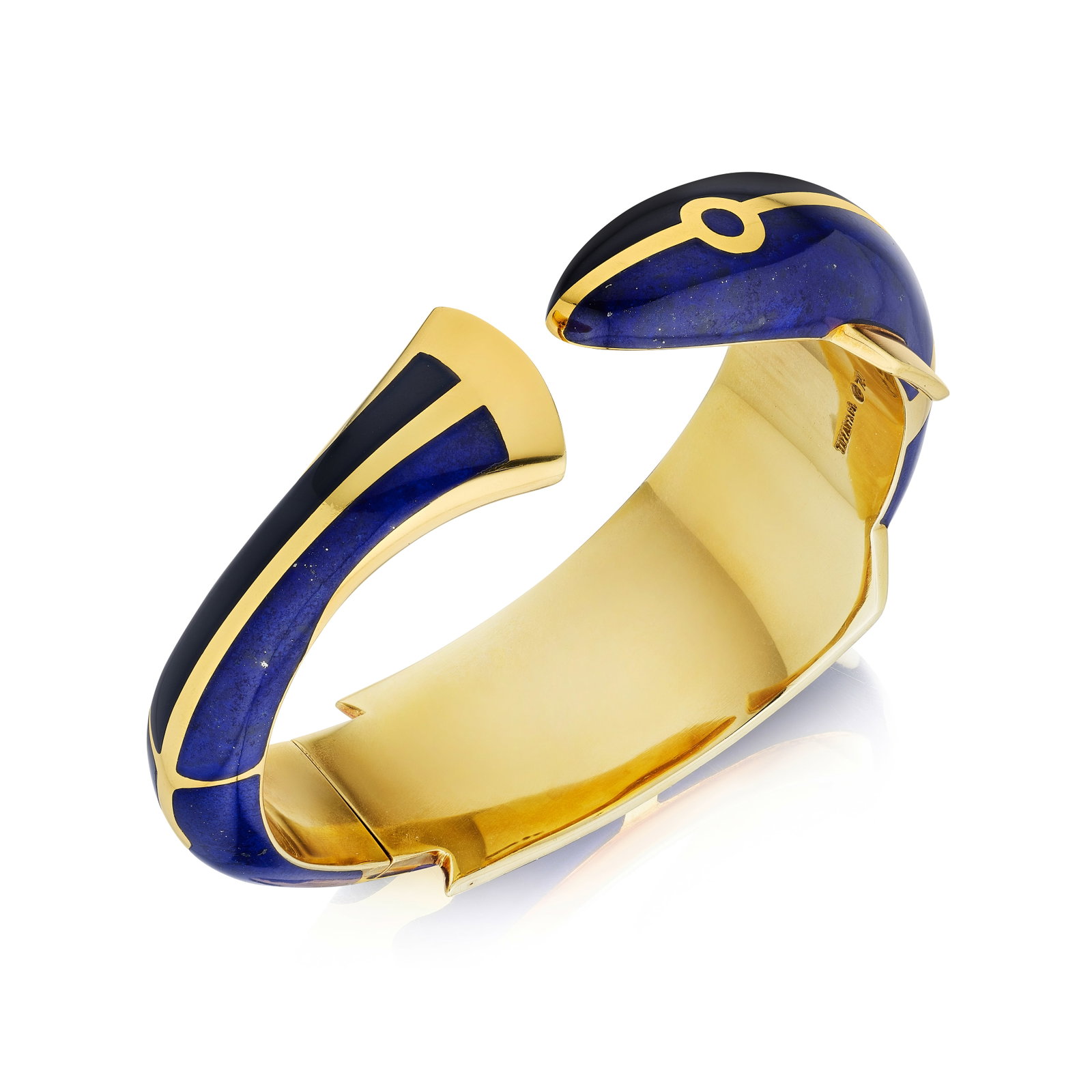 ANGELA CUMMINGS FOR TIFFANY & CO.: A LAPIS LAZULI AND ONYX CUFF: ANGELA CUMMINGS FOR TIFFANY & CO.: A LAPIS LAZULI AND ONYX CUFF Designed as a fish, with carved lapis lazuli and onyx inlay; signed TIFFANY&CO.; mounted in 18K gold; inner circumference 6¾ in;