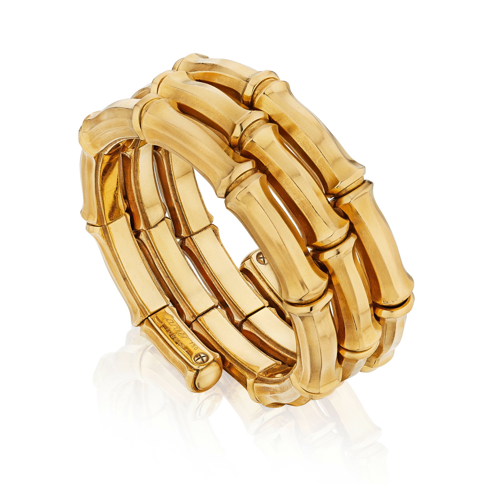 CARTIER: AN 18K GOLD BRACELET, FRANCE, CIRCA 1970: CARTIER: AN 18K GOLD BRACELET, FRANCE, CIRCA 1970 Designed as a triple spiral bracelet of a repeating bamboo motif; signed Cartier, no. 709946; with maker's mark and French assay mark; gross