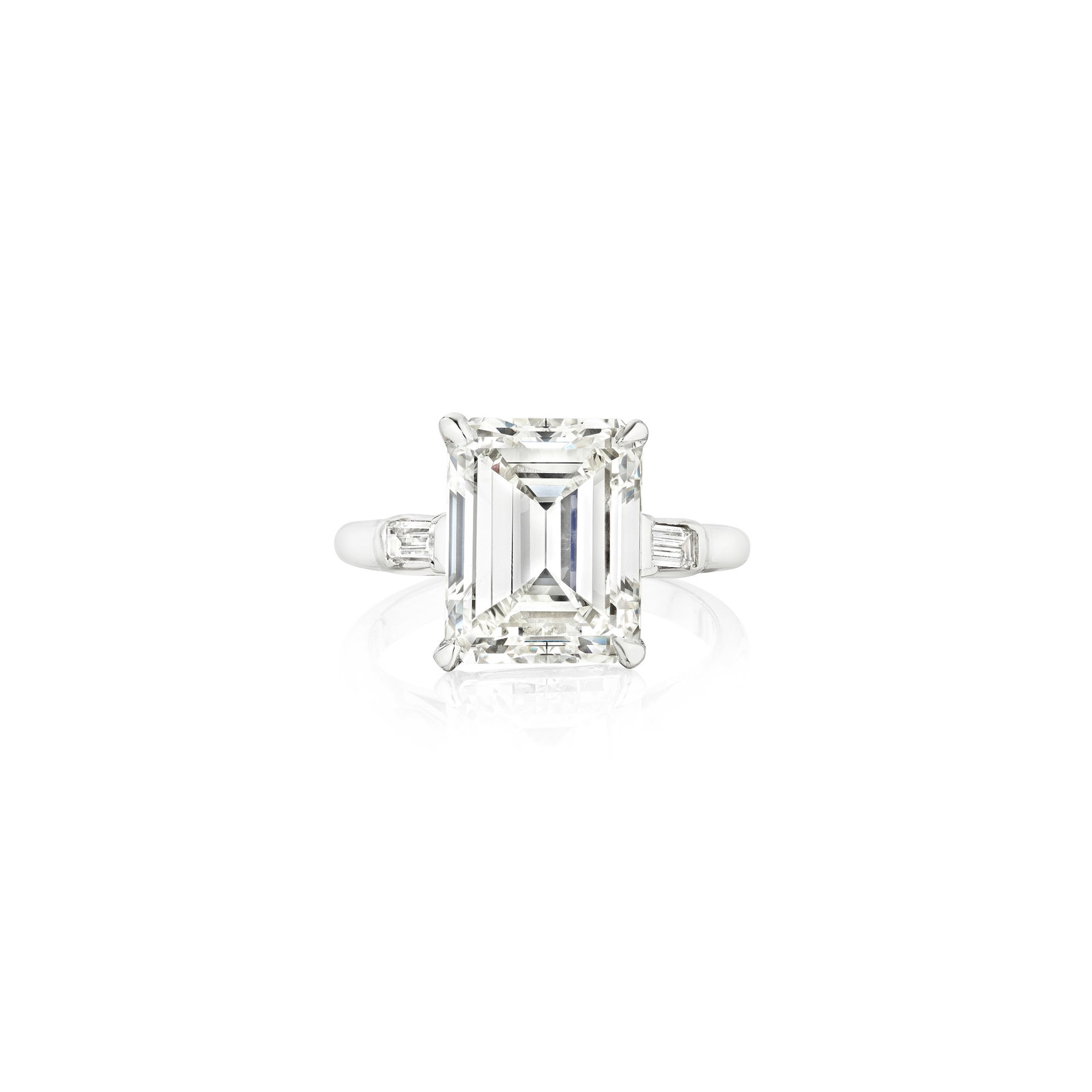 A DIAMOND RING: A DIAMOND RING Centering an emerald-cut diamond, weighing 6.13 carats, flanked by tapered baguette-cut diamonds; mounted in platinum; size 6¾ Footnotes: Accompanied by GIA report stating that the