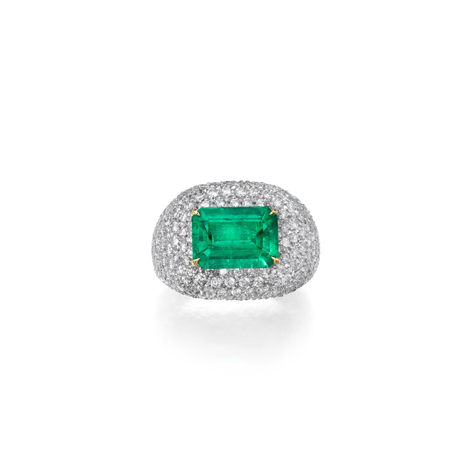AN EMERALD AND DIAMOND RING, ITALY: AN EMERALD AND DIAMOND RING, ITALY Of bombé design centering an emerald-cut emerald, weighing 2.89 carats, set throughout with round brilliant-cut diamonds; with maker's mark and Italian
