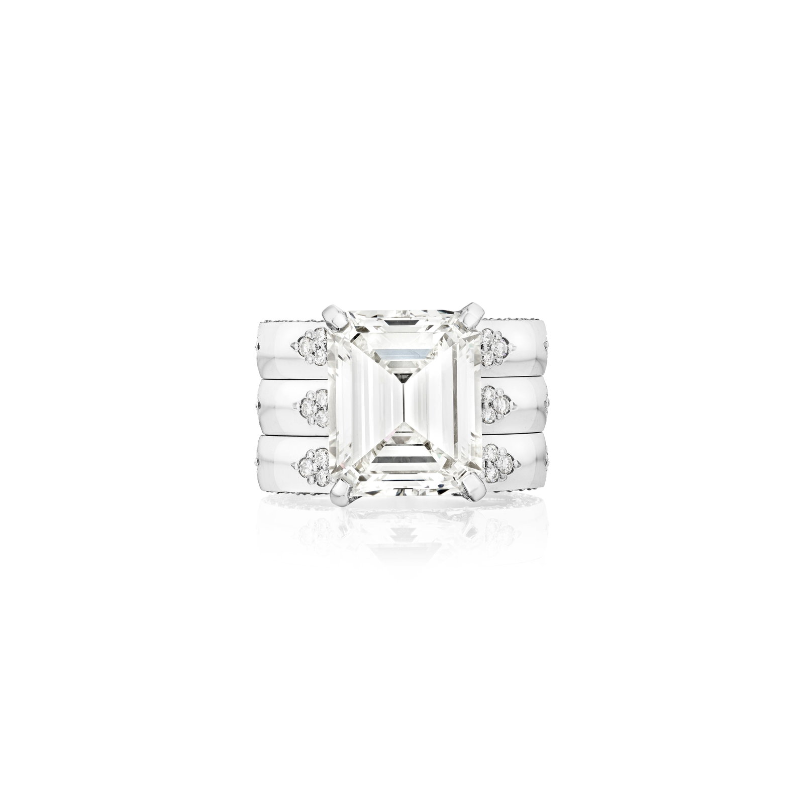 A DIAMOND RING: A DIAMOND RING Centering an emerald-cut diamond, weighing 8.10 carats, to a triple band accented by round brilliant-cut diamond; signed MICHAEL.B; estimated remaining diamond weight size 6¾