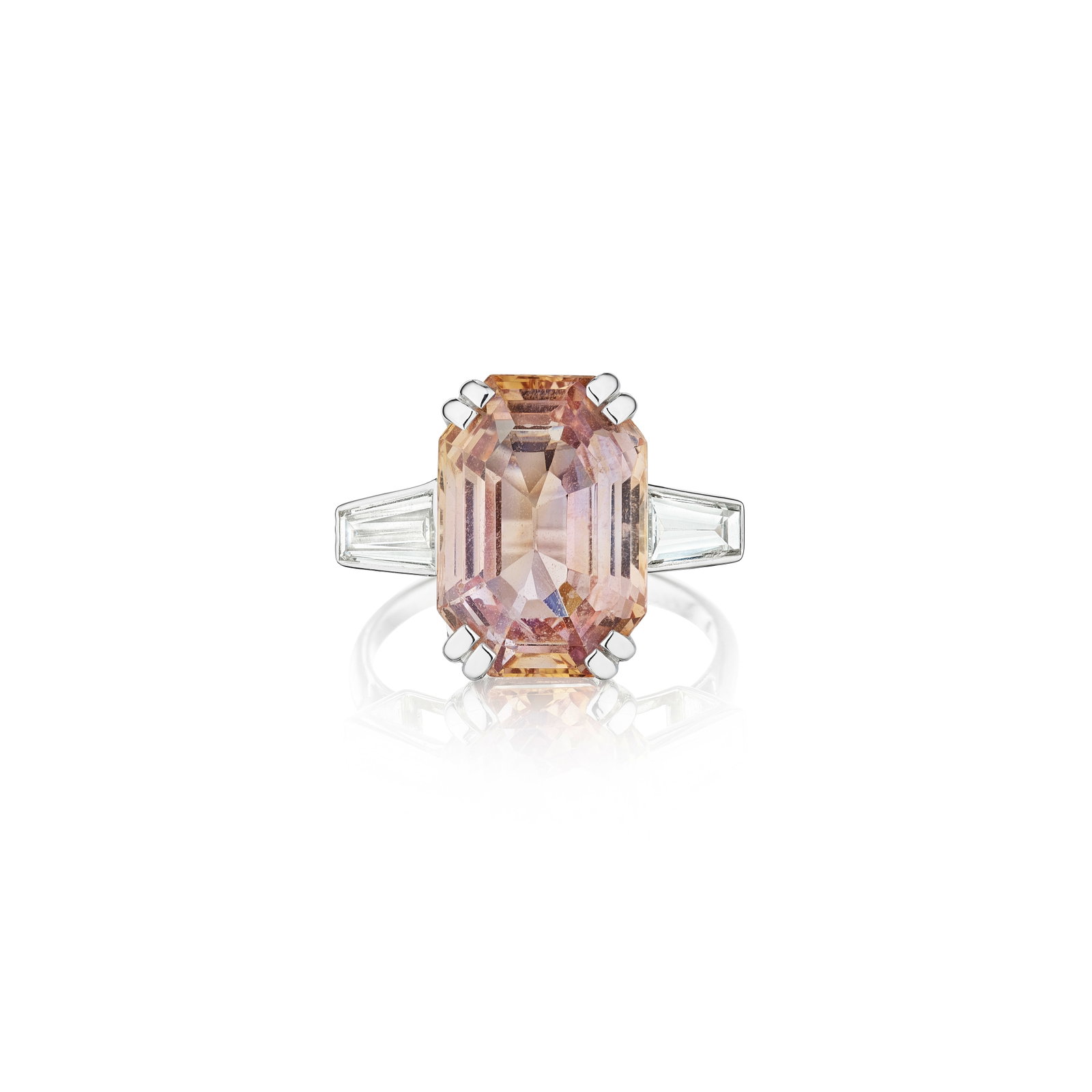 CHAUMET: A PADPARADSCHA SAPPHIRE AND DIAMOND RING, FRANCE: CHAUMET: A PADPARADSCHA SAPPHIRE AND DIAMOND RING, FRANCE Centering a step-cut Padparadscha sapphire, weighing 9.48 carats, flanked by two tapered baguette-cut diamonds; signed CHAUMET.PARIS., no.