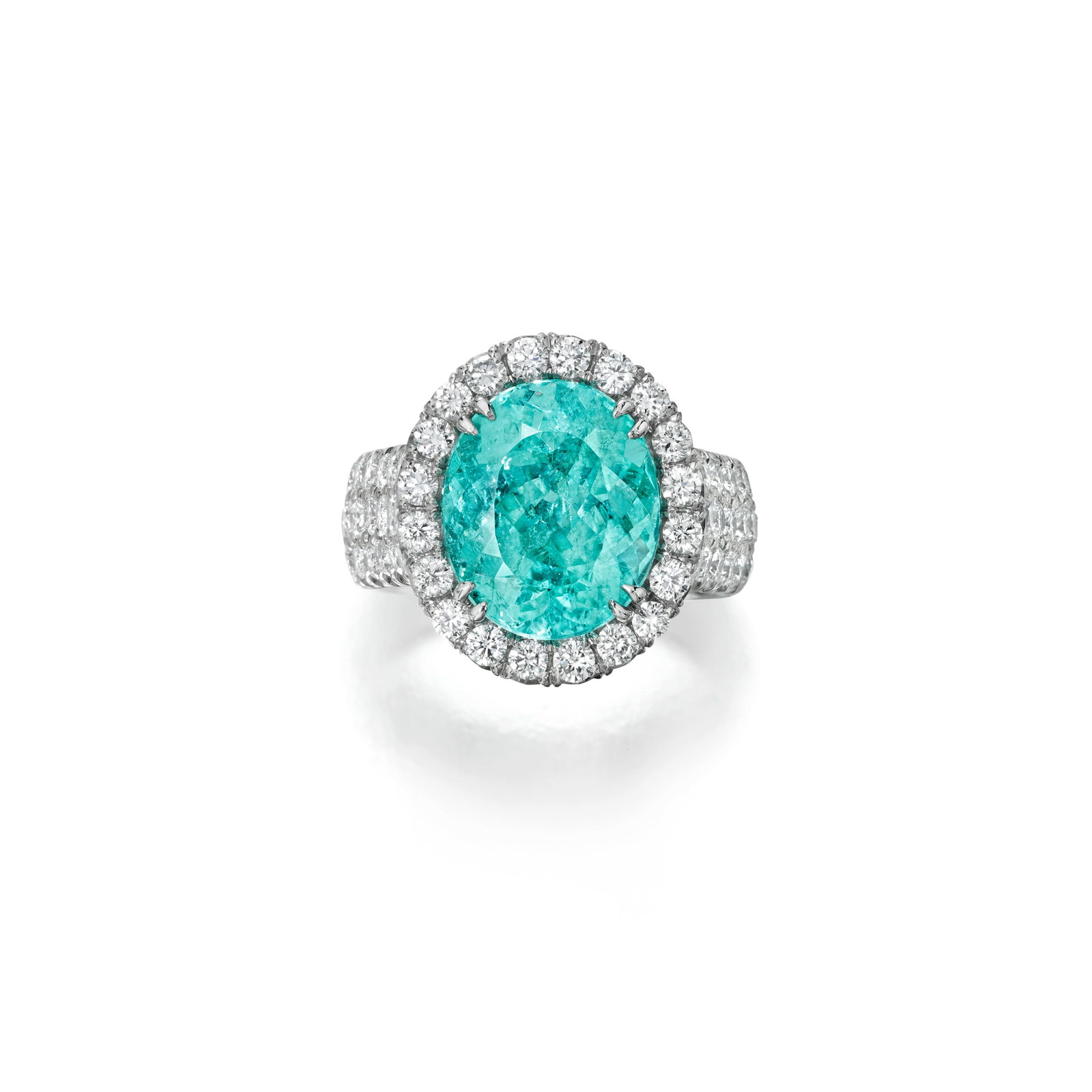 A PARAÍBA-TYPE TOURMALINE AND DIAMOND RING: A PARAÍBA-TYPE TOURMALINE AND DIAMOND RING Centering an oval-shaped Paraíba-type tourmaline, weighing 7.57 carats, within a round brilliant-cut diamond-set frame; with maker's mark;
