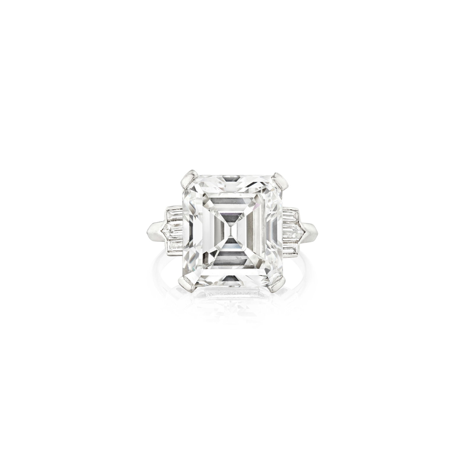 A DIAMOND RING: A DIAMOND RING Centering an emerald-cut diamond, weighing 8.29 carats, flanked by step-cut diamonds; mounted in platinum; size 4 Footnotes: Accompanied by GIA report stating that the diamond is G colo