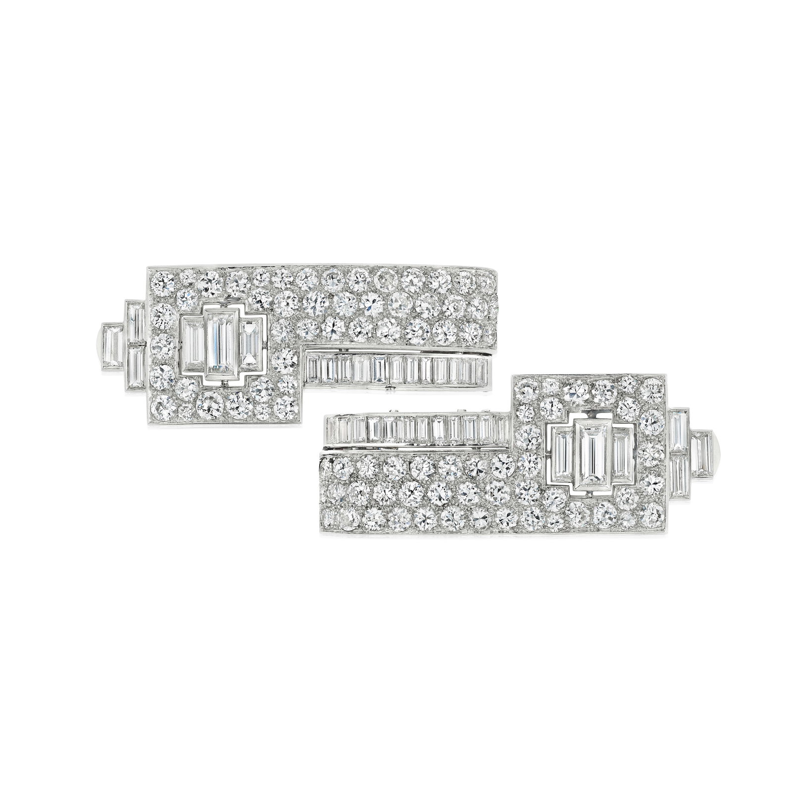 CHAUMET: A PAIR OF DIAMOND CLIPS, FRANCE, CIRCA 1950: CHAUMET: A PAIR OF DIAMOND CLIPS, FRANCE, CIRCA 1950 Each centering three baguette-cut diamonds, within a geometric frame set throughout with round brilliant-cut and old European-cut diamonds,